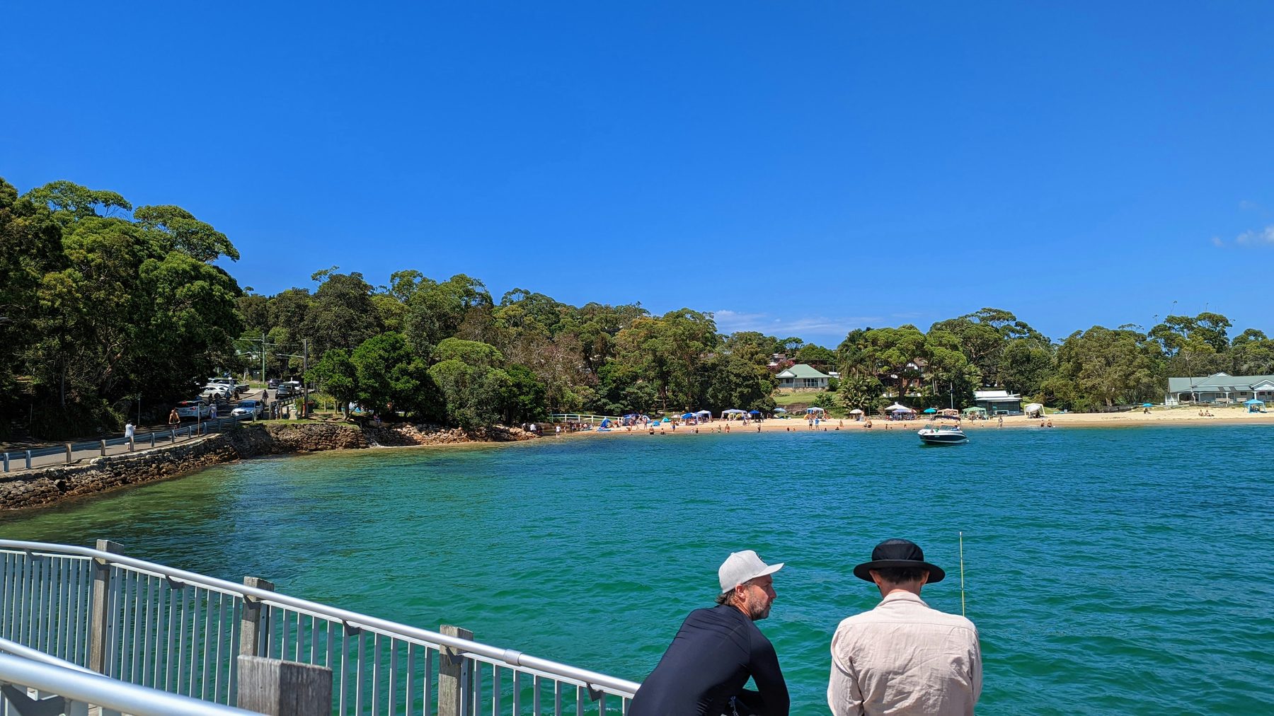 Two people watching the water at a Sydney coastal bay