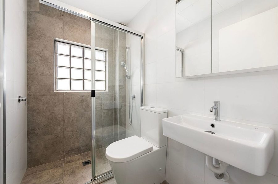 Private bathroom with walk-in shower in a Caring Pathways studio